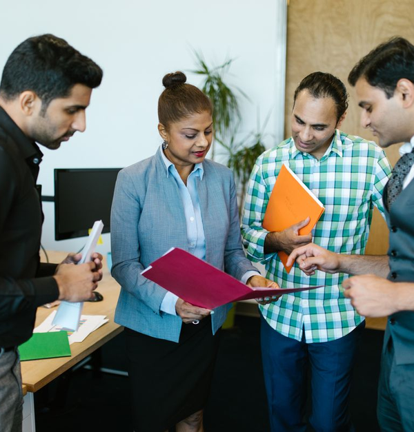 Indian professionals reviewing business documents